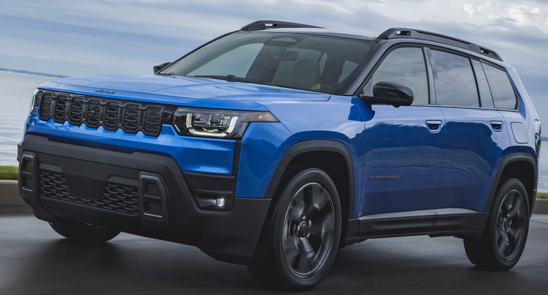 2026 Jeep® Cherokee driving next to body of water